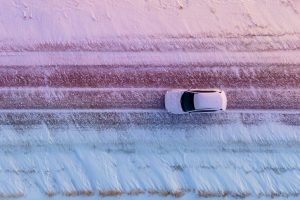 White car in a snowy road
