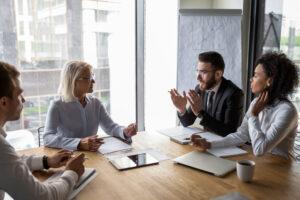 A lawyer meets with his clients who are wondering what to ask a truck accident lawyer in the aftermath of a collision.